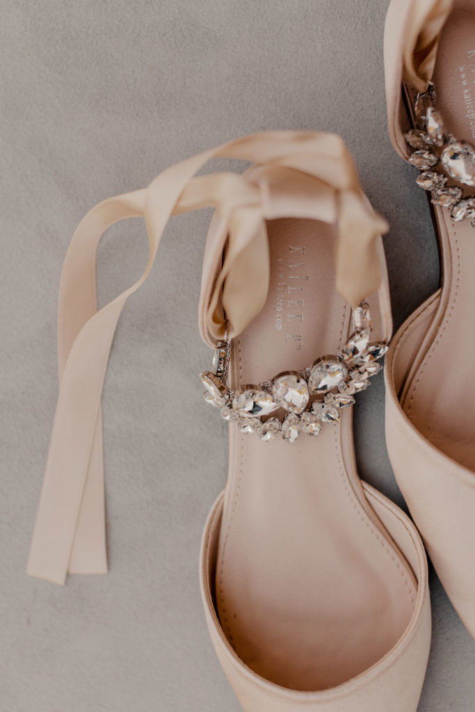 wedding day details with wedding rings and wedding shoes