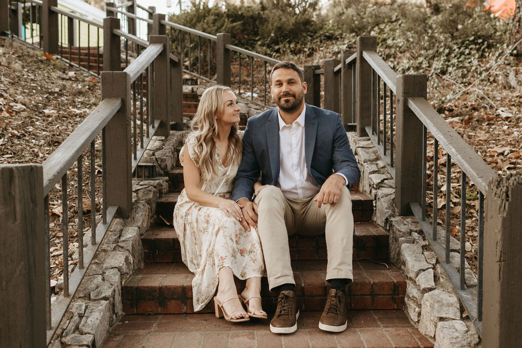 couple sitting on stairs at engagement session