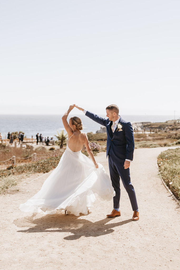 groom spinning bride around on pismo beach california
