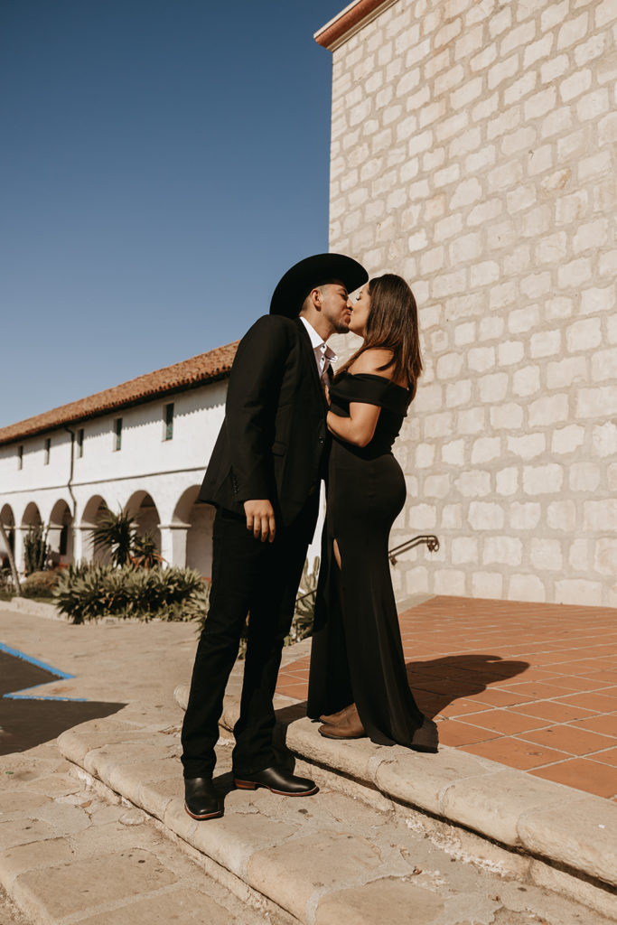 couple standing in front of mission for picture