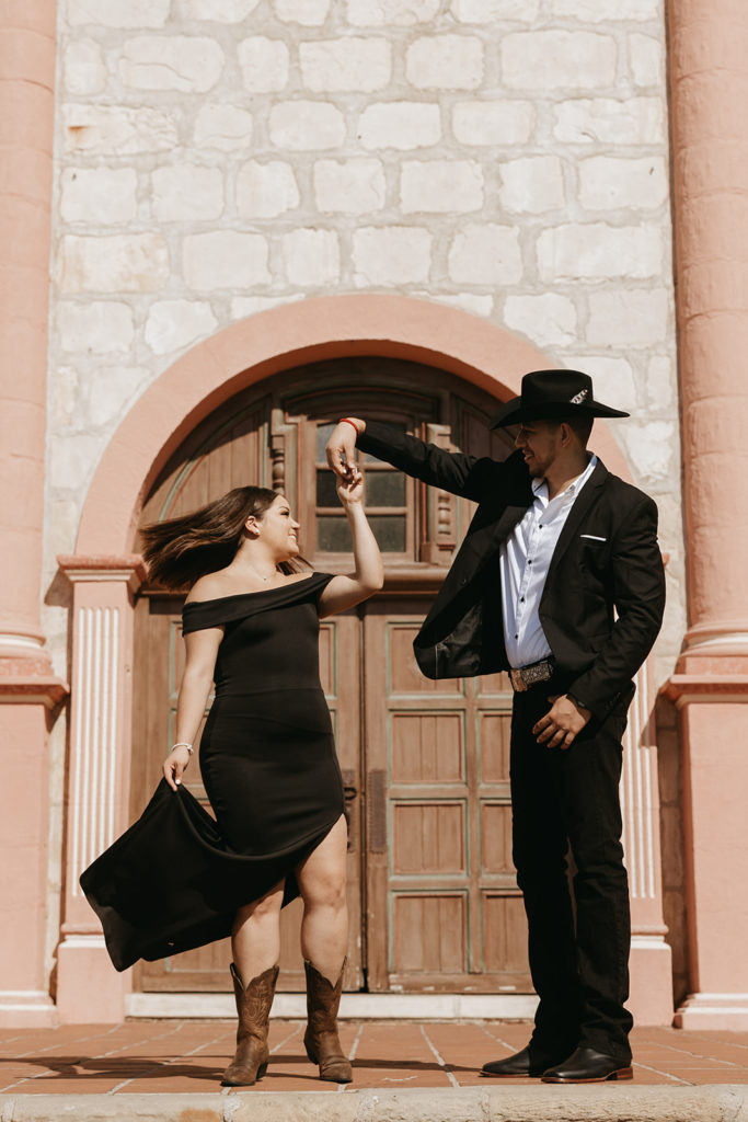 couple standing in front of mission for picture