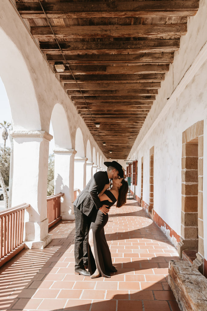 couple standing in front of mission for picture