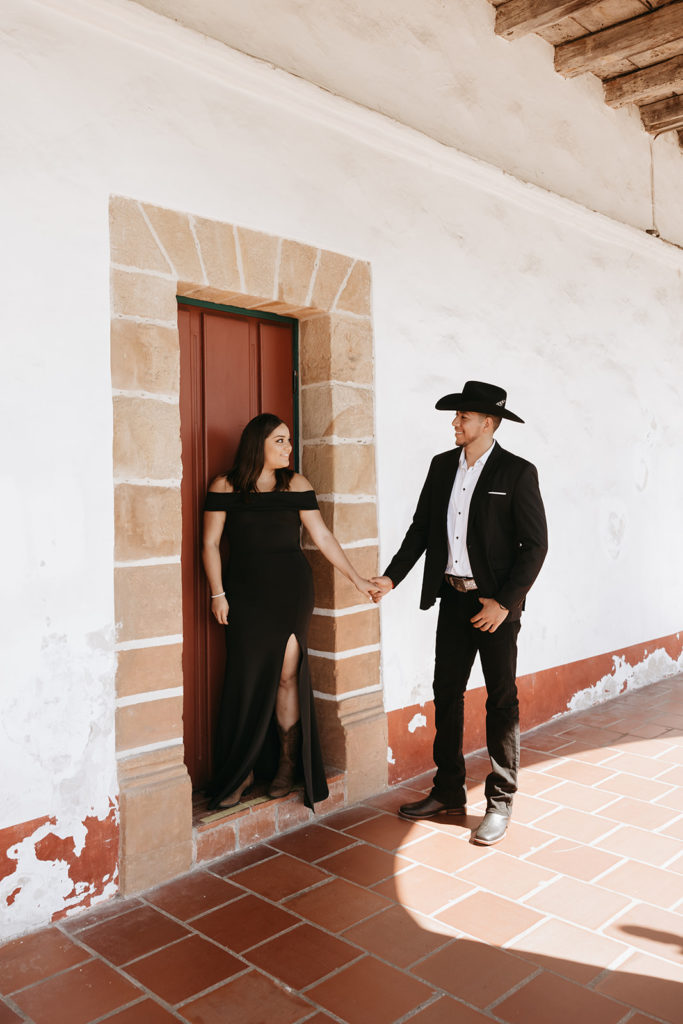 couple standing in front of mission for picture