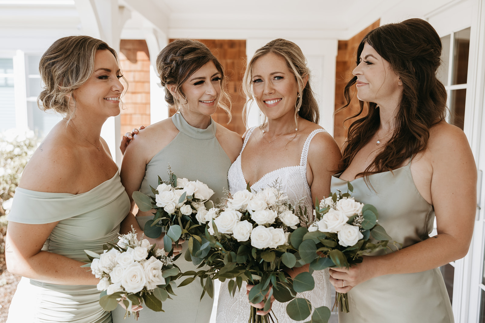 bridesmaids posing with wedding flowers | The Penny: A Downtown Wedding Venue in San Luis Obispo