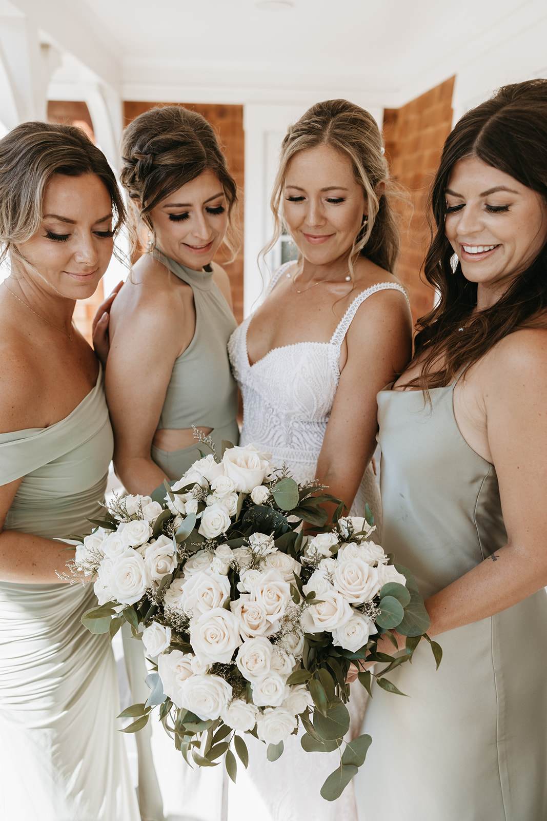 bridesmaids posing with wedding flowers