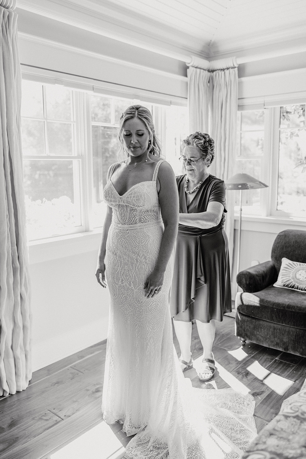 bride getting help zippering her dress | The Penny: A Downtown Wedding Venue in San Luis Obispo