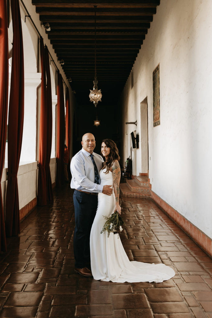 new bride and groom posing after their courthouse elopement in santa Barbara 