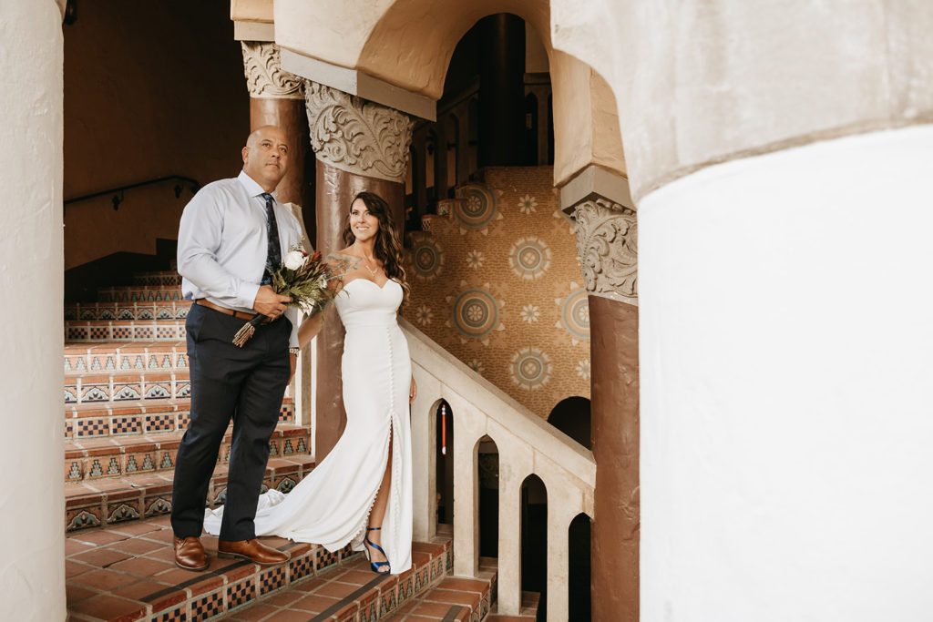 new bride and groom posing after their courthouse elopement in santa Barbara.
