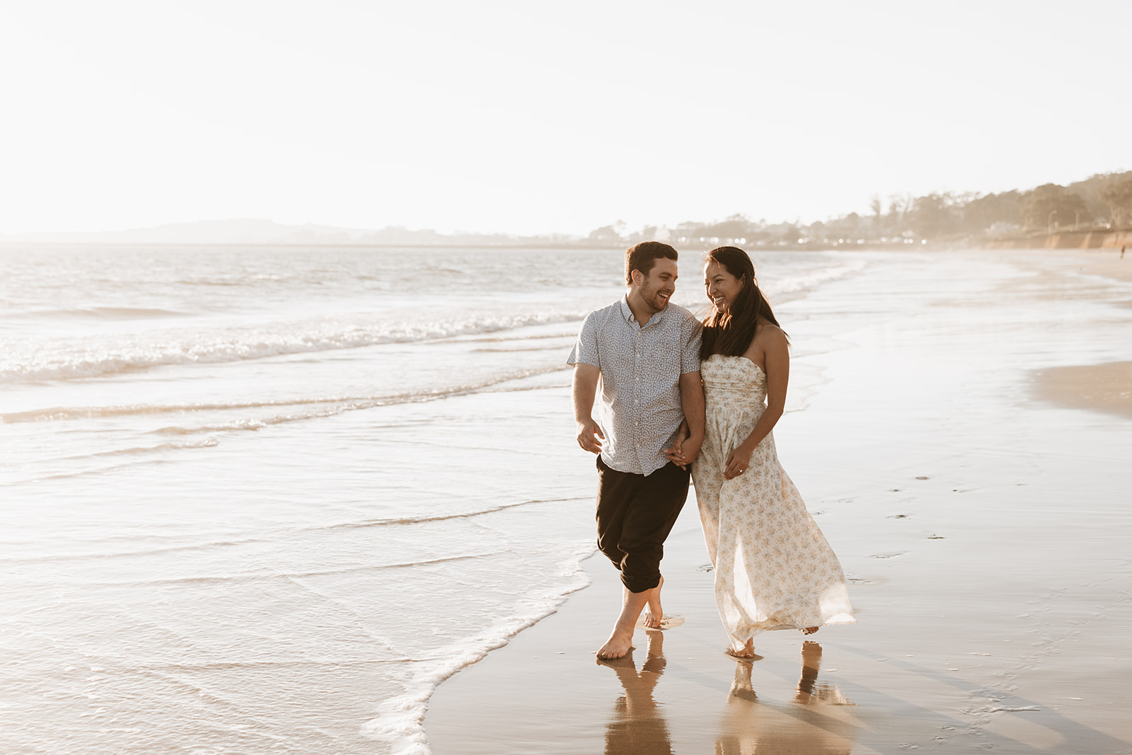 couple walking and posing on the beach after their surprise beach proposal