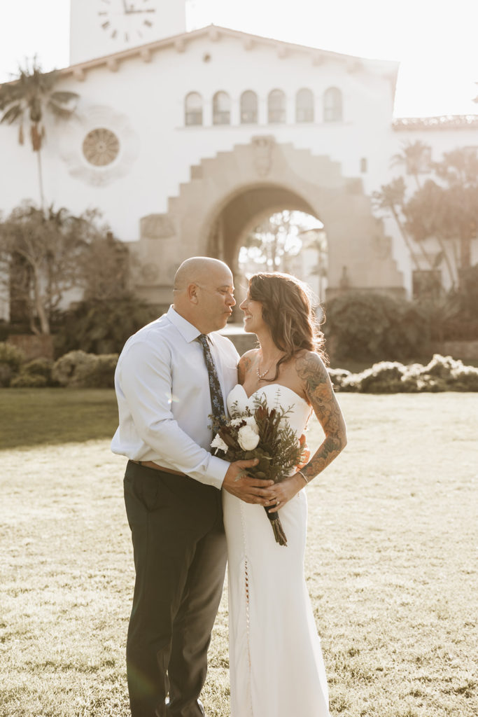 couple posing for their elopement photos at a courthouse in santa barbara