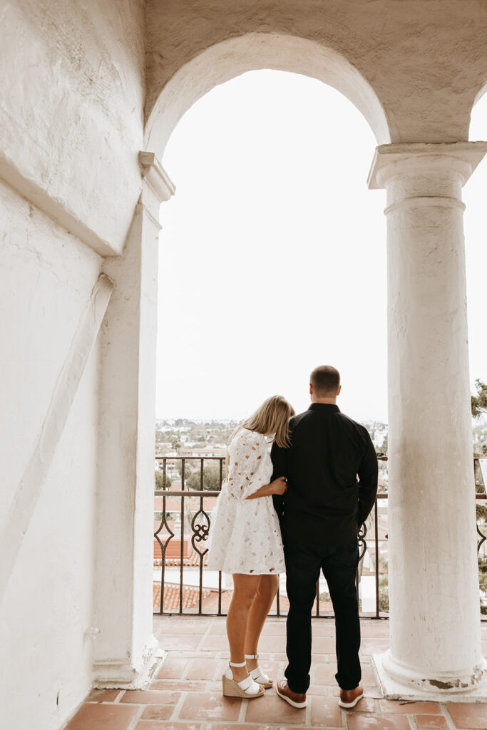 couple at a courthouse posing for their engagement photos in santa barbara