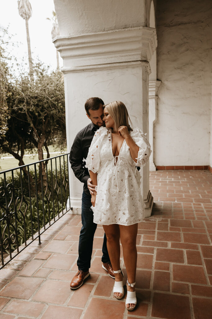 couple at a courthouse posing for their engagement photos in santa barbara