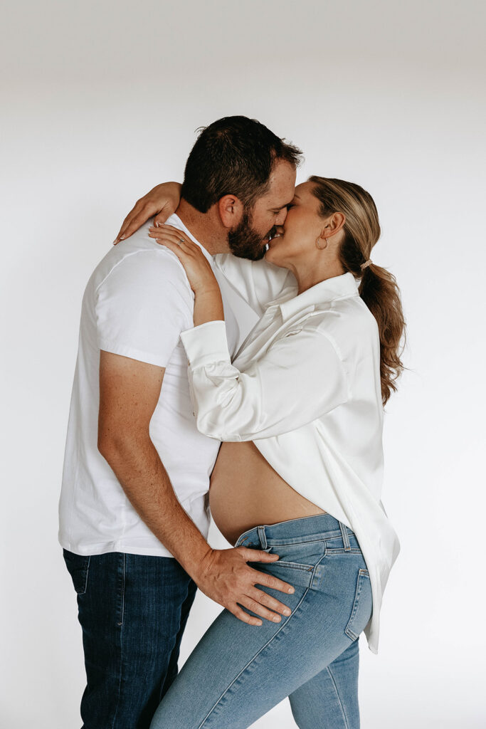 a couple posing for their maternity photoshoot to celebrate a lifetime milestone