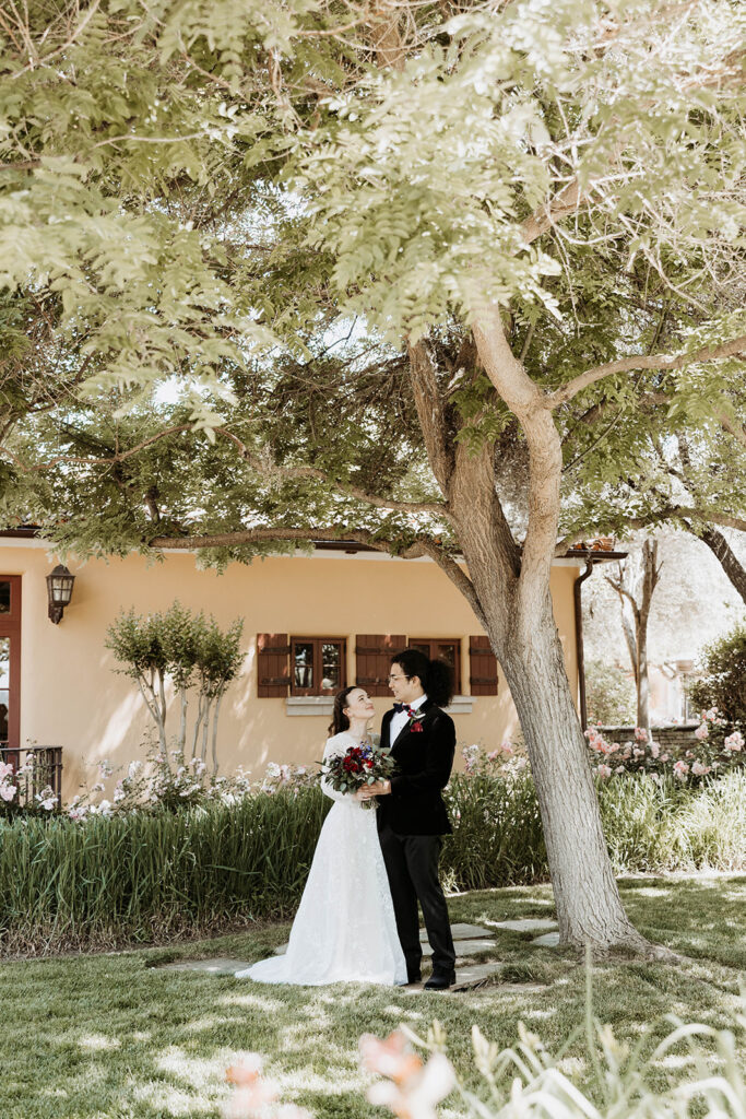 bride and groom posing in a california winery for their wedding portraits