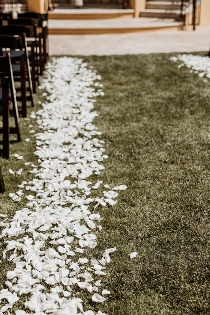 wedding ceremony aisle with white flower petals