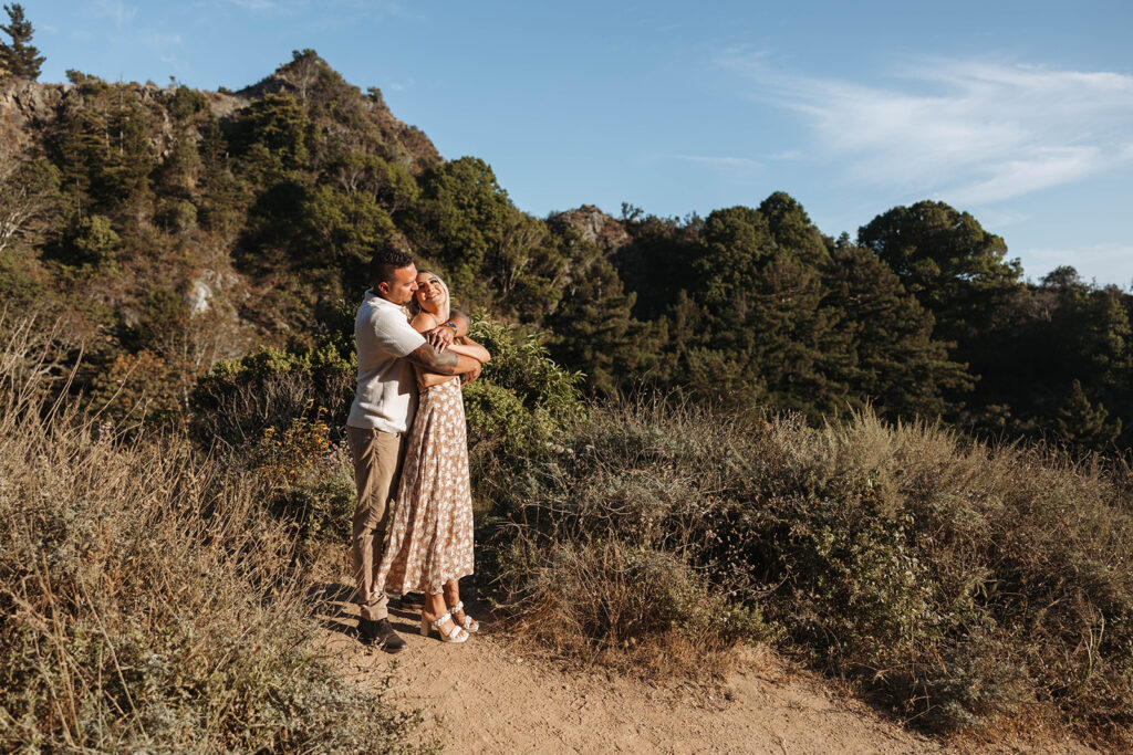 couple posing in the cliffs of big sur for their engagement photos
