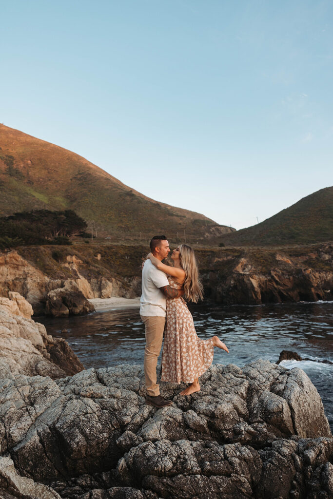 couple posing in the cliffs of big sur for their engagement photos
