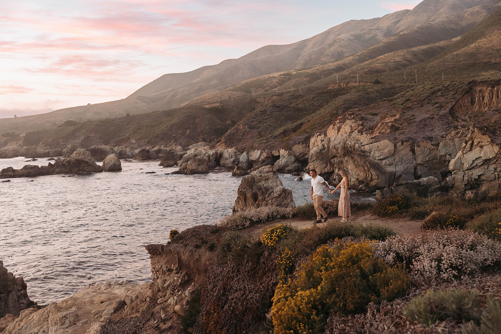couple posing in the cliffs of big sur for their engagement photos