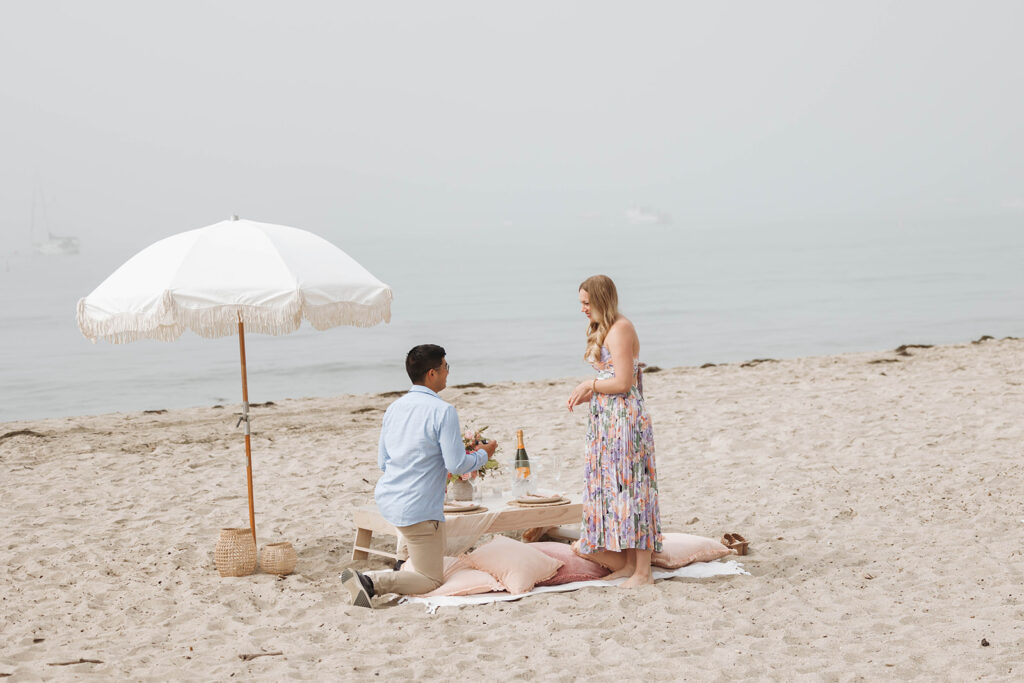 couple on the beach in santa barbara for a surprise proposal
