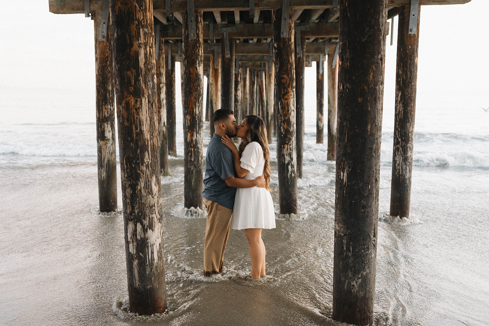 couple posing on a beach in central california for a photoshoot