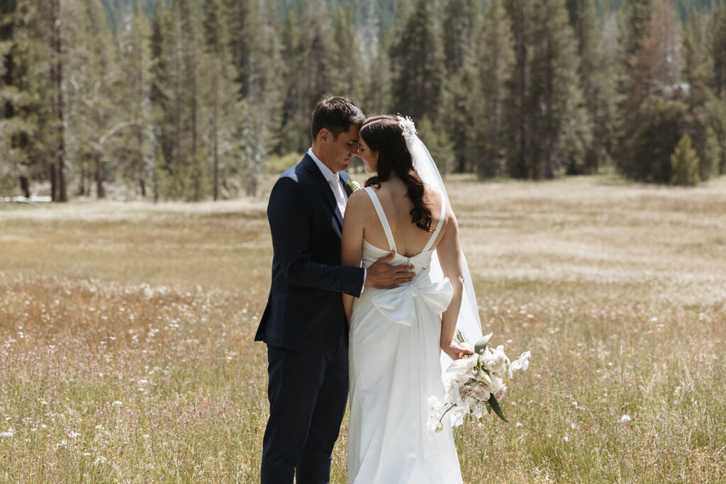 bride and groom posing for outdoor wedding photos
