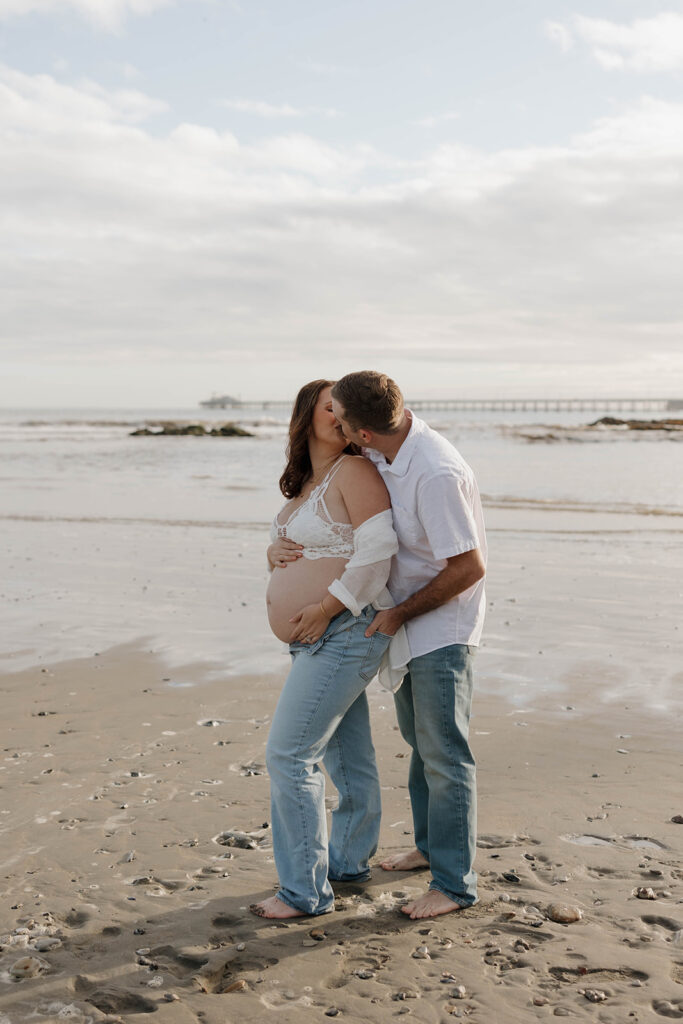 a family milestone maternity photoshoot with mom dad and kids
