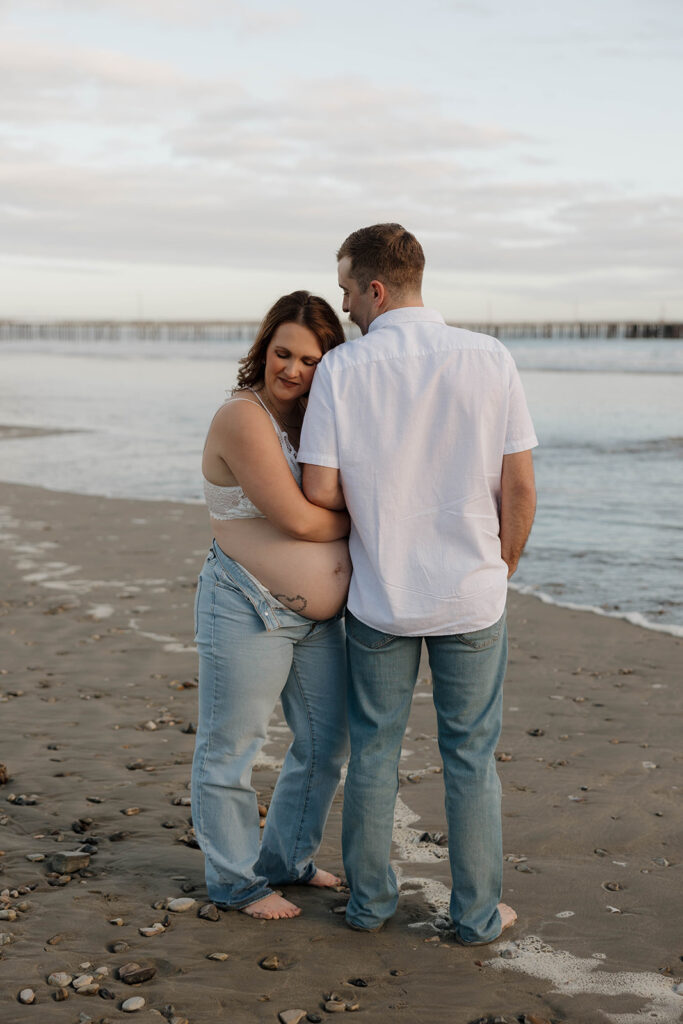 a family milestone maternity photoshoot with mom dad and kids
