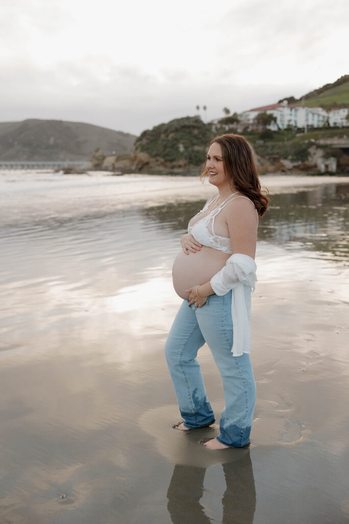 a family maternity photoshoot on the beach in california
