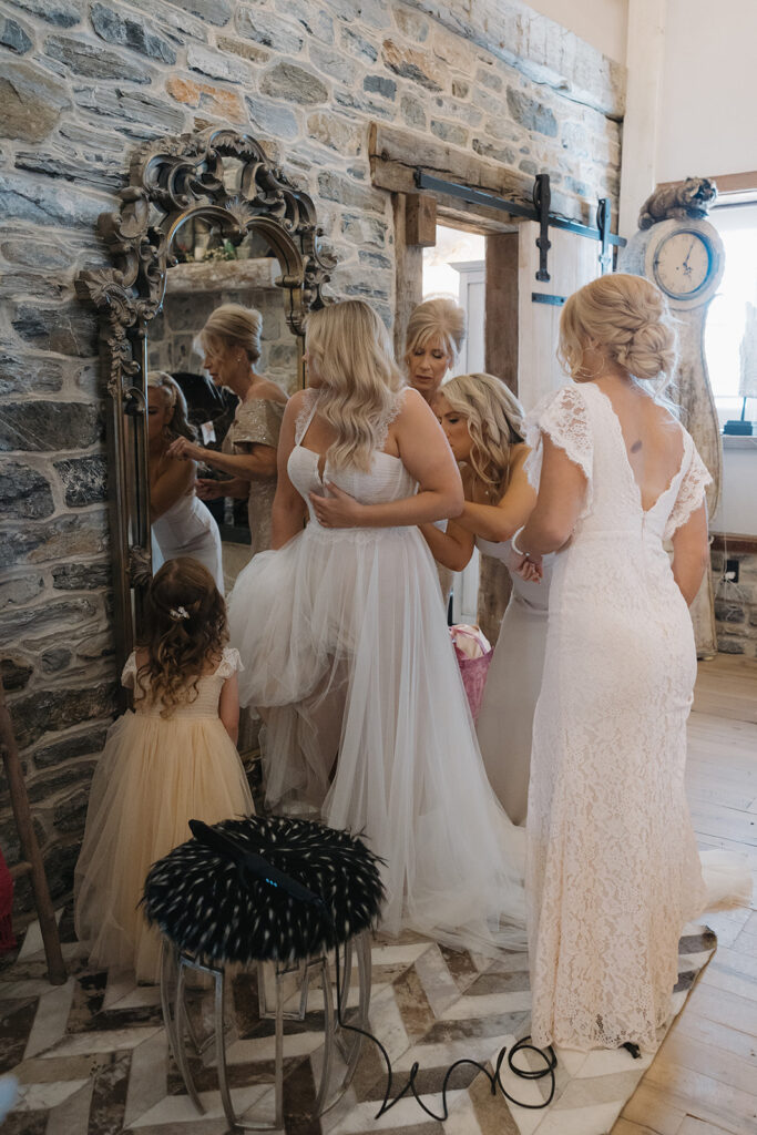 woman trying on her wedding gown
