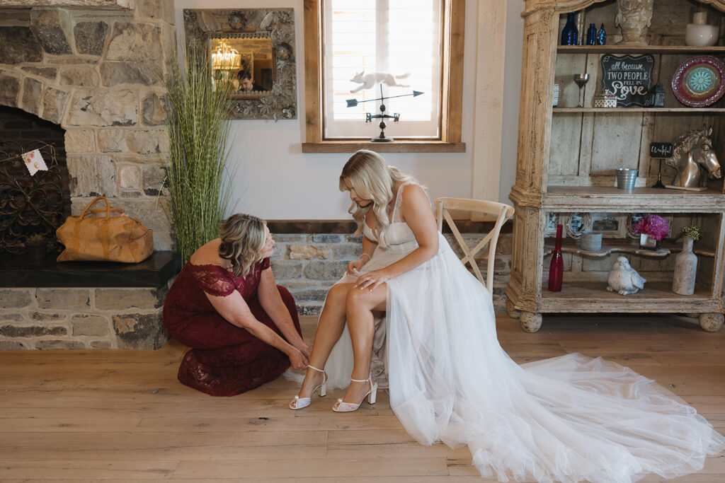 woman trying on her wedding gown
