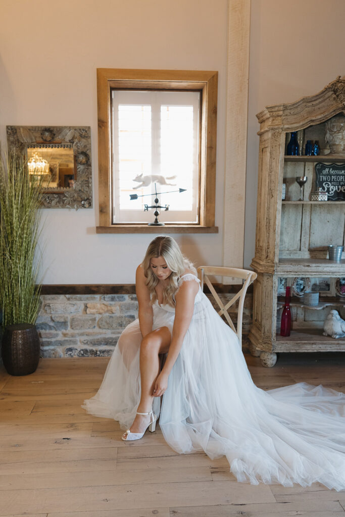 bride putting on her wedding dress
