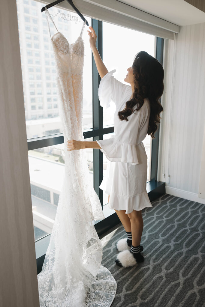 woman trying on her wedding gown
