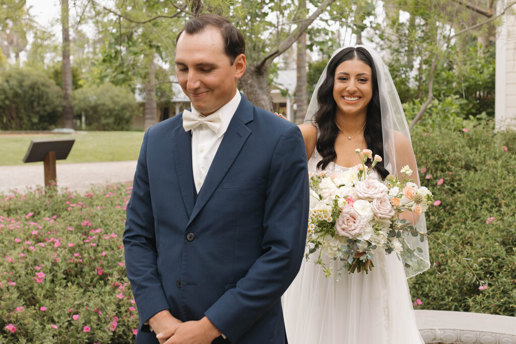  bride and groom having a first look photoshoot
