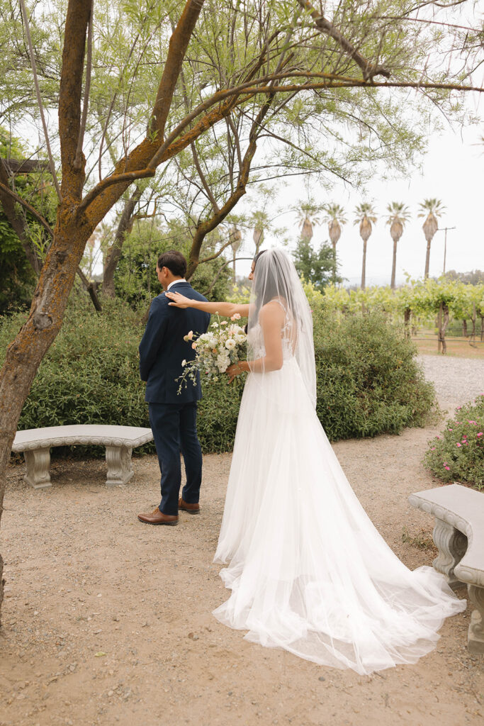  bride and groom having a first look photoshoot
