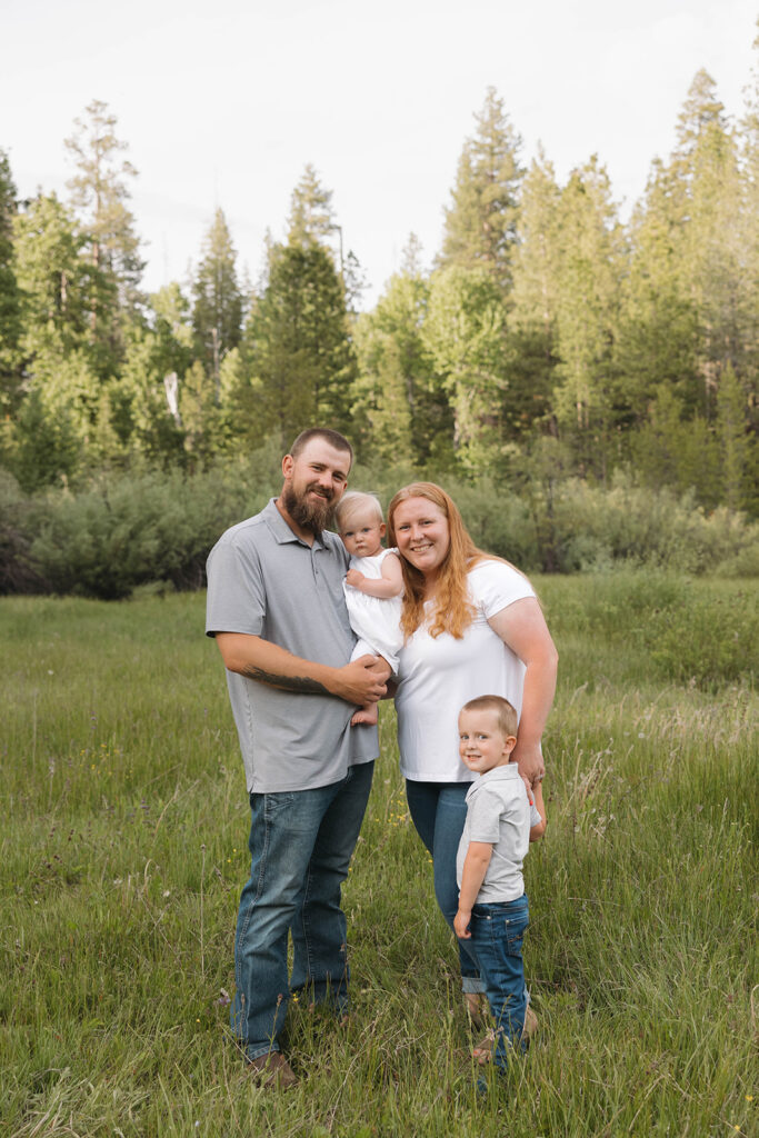 family taking pictures in a field
