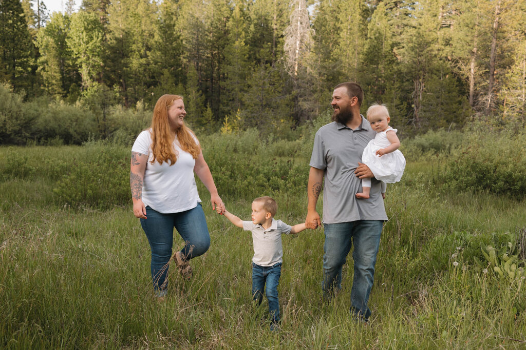 family taking pictures in a field
