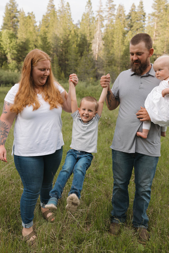 family taking pictures in a field
